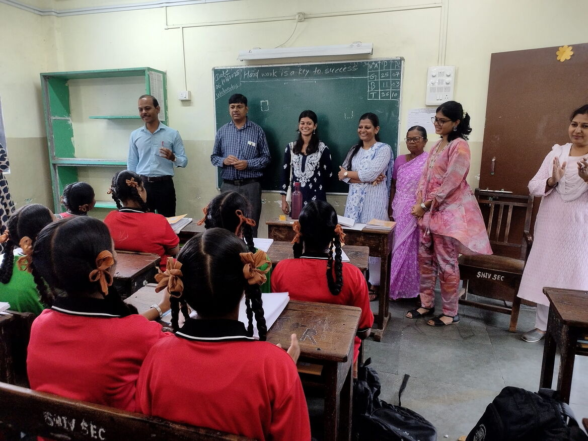   Girl celebrating birthday with BMC school children while serving meals at Sion MPS school